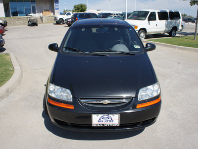 chevrolet aveo 2004 black hatchback gasoline 4 cylinders front wheel drive 5 speed manual 76205