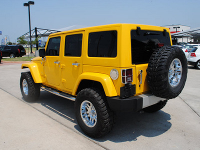 jeep wrangler unlimited 2011 yellow suv sahara gasoline 6 cylinders 4 wheel drive automatic with overdrive 76087