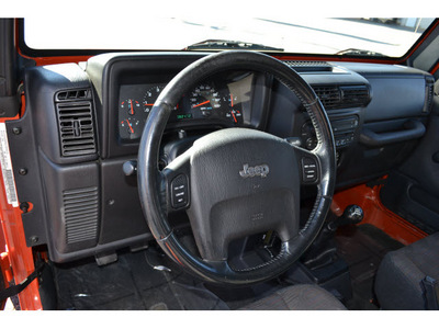 jeep wrangler 2005 orange suv rubicon gasoline 6 cylinders 4 wheel drive 6 speed manual 76903