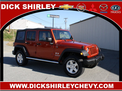 jeep wrangler unlimited 2009 orange suv x gasoline 6 cylinders 4 wheel drive automatic 27215