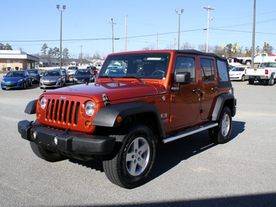 jeep wrangler unlimited 2009 orange suv x gasoline 6 cylinders 4 wheel drive automatic 27215