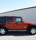 jeep wrangler unlimited 2009 orange suv x gasoline 6 cylinders 4 wheel drive automatic 27215