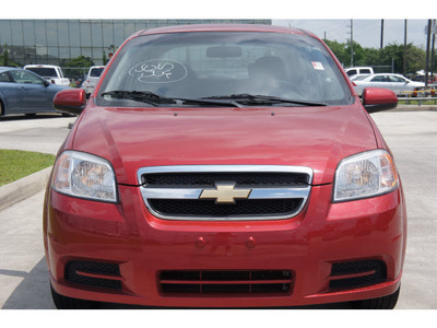 chevrolet aveo 2011 red sedan lt gasoline 4 cylinders front wheel drive automatic 77090