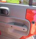 jeep wrangler unlimited 2009 orange suv sahara gasoline 6 cylinders 4 wheel drive automatic 62863