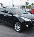 hyundai tucson 2011 black limited gasoline 4 cylinders front wheel drive automatic 33021