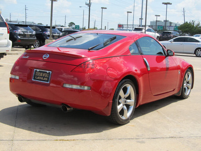 nissan 350z 2006 red coupe gasoline 6 cylinders rear wheel drive 6 speed manual 77074