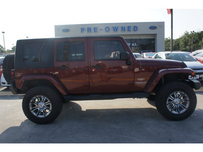 jeep wrangler unlimited 2009 red suv sahara gasoline 6 cylinders 4 wheel drive automatic 77338