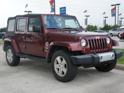 jeep wrangler unlimited 2009 red suv sahara gasoline 6 cylinders 4 wheel drive automatic 77090