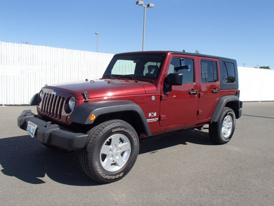 jeep wrangler unlimited 2009 red suv x gasoline 6 cylinders 4 wheel drive automatic 99352