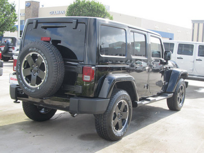 jeep wrangler unlimited 2012 black suv sahara gasoline 6 cylinders 4 wheel drive automatic with overdrive 77099