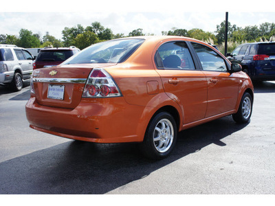chevrolet aveo 2007 orange sedan lt 4 cylinders automatic 77074