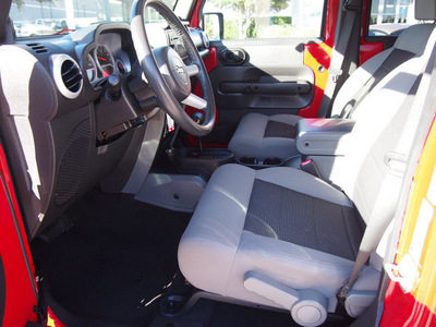 jeep wrangler unlimited 2010 red suv sahara gasoline 6 cylinders 4 wheel drive automatic with overdrive 76011