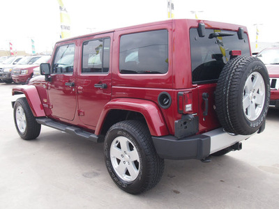 jeep wrangler unlimited 2012 red suv sahara gasoline 6 cylinders 4 wheel drive automatic 77388
